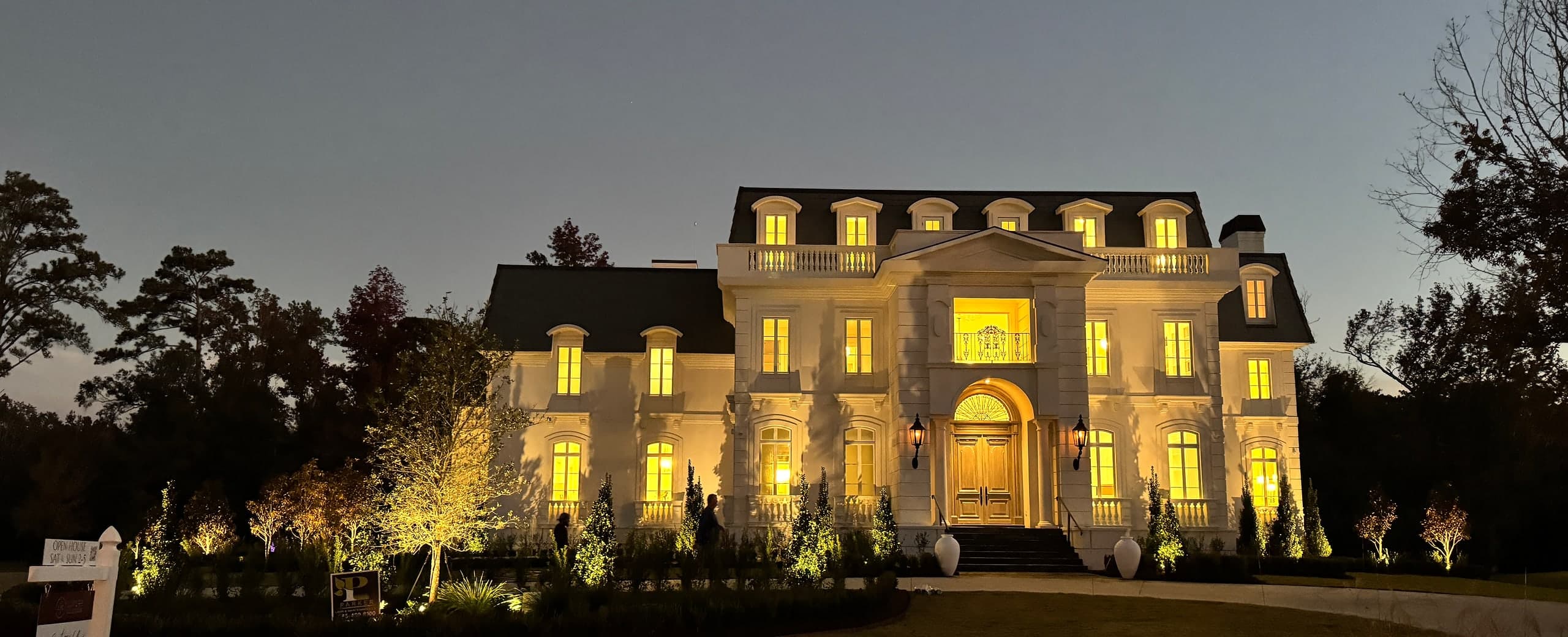 Belle Maison — the illuminated front elevation at dusk