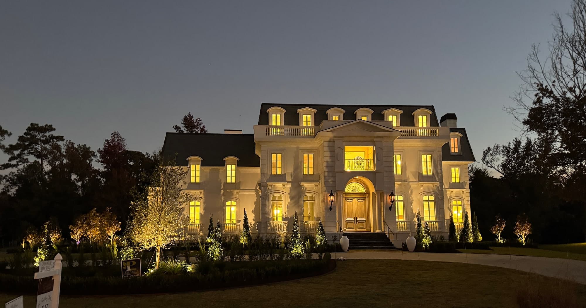 Belle Maison — the illuminated front elevation at dusk